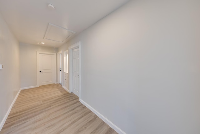 hallway with light wood-style floors and baseboards