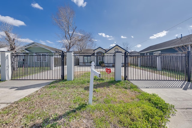 view of gate featuring a fenced front yard and a yard