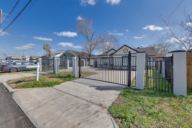 view of gate with a fenced front yard