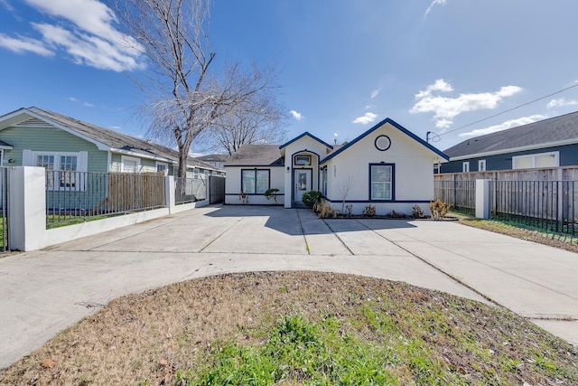 view of front of home featuring fence private yard and stucco siding