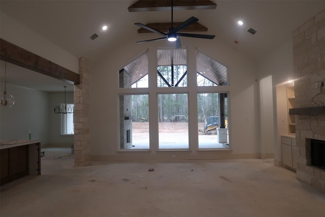 unfurnished living room with high vaulted ceiling, ceiling fan with notable chandelier, a fireplace, visible vents, and beamed ceiling