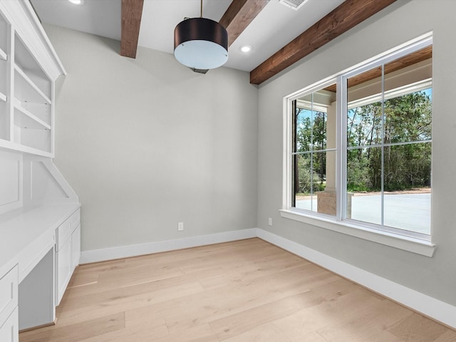 empty room with visible vents, baseboards, beamed ceiling, light wood-style floors, and recessed lighting