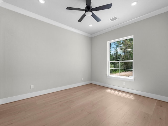 unfurnished room featuring light wood-style flooring, visible vents, baseboards, and ornamental molding