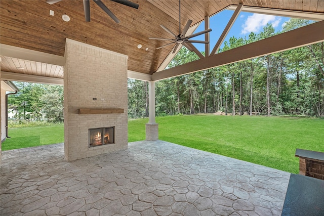 view of patio with an outdoor brick fireplace and ceiling fan