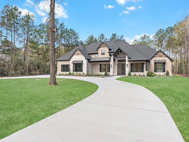 15681 Connie Ln, Montgomery, TX 77316 - view of front of home with a standing seam roof, curved driveway, roof with shingles, a front yard, and metal roof