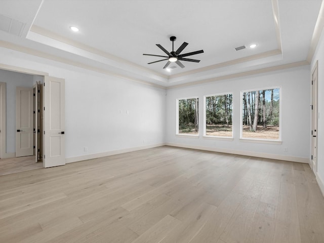 15681 Connie Ln, Montgomery, TX 77316 - spare room with light wood-type flooring, visible vents, a ceiling fan, baseboards, and a raised ceiling