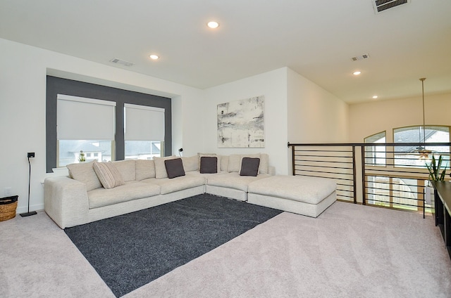 carpeted living room with recessed lighting and visible vents