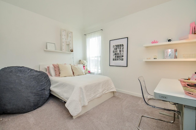 bedroom featuring carpet and baseboards