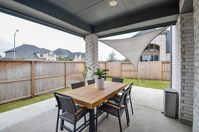 view of patio with outdoor dining area and a fenced backyard