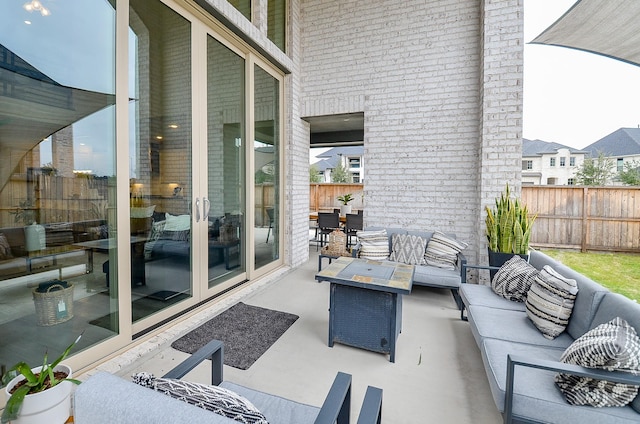 view of patio featuring an outdoor hangout area and fence