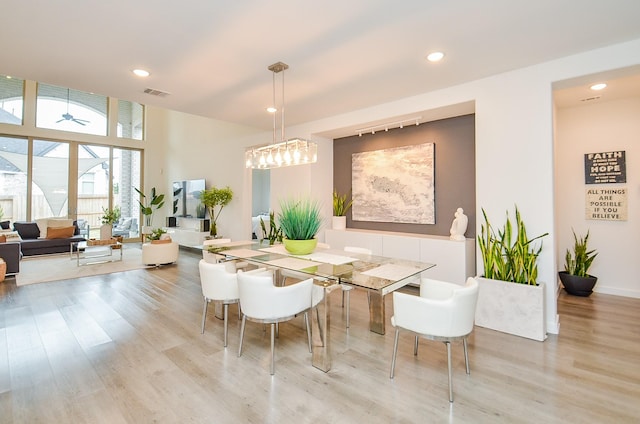 dining room featuring light wood finished floors, visible vents, and recessed lighting