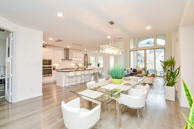 interior space with baseboards, light wood finished floors, visible vents, and recessed lighting