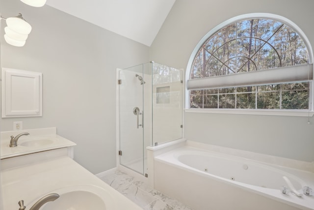 bathroom featuring marble finish floor, a sink, a jetted tub, a shower stall, and lofted ceiling