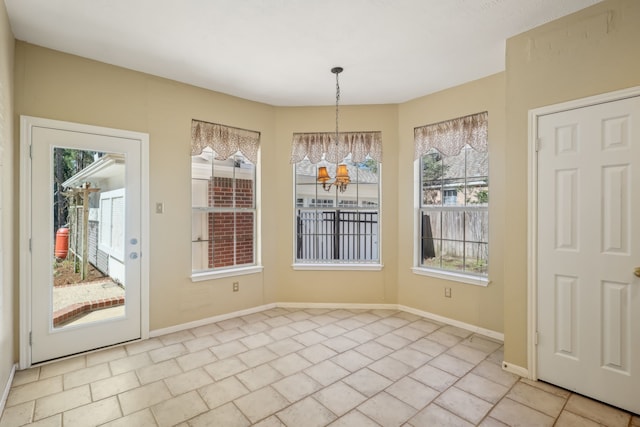 unfurnished dining area with baseboards