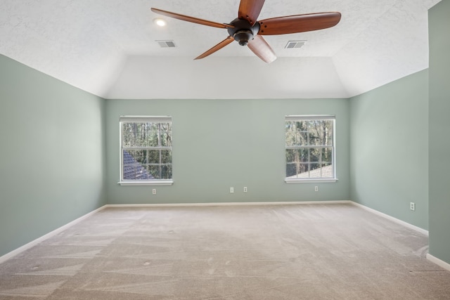 spare room with lofted ceiling, a ceiling fan, and baseboards