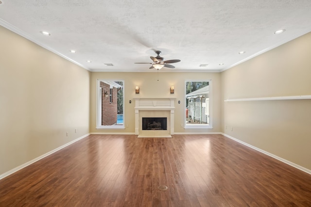 19 Shady Pond Pl, The Woodlands, TX 77382 - unfurnished living room with a ceiling fan, a fireplace with flush hearth, wood finished floors, baseboards, and crown molding