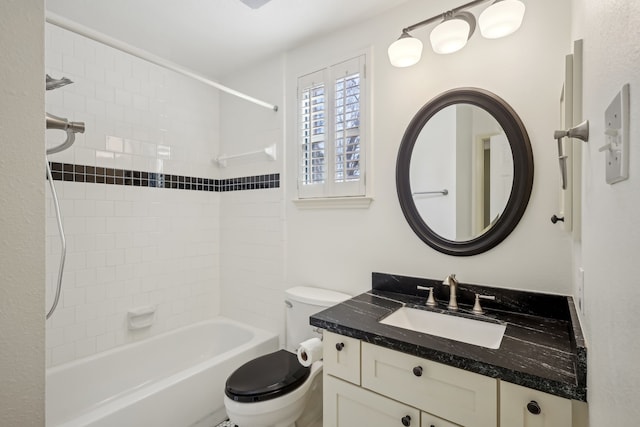 bathroom with toilet, vanity, and washtub / shower combination