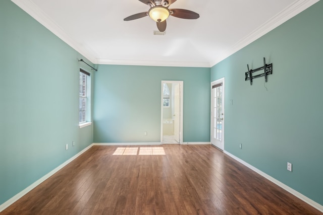 spare room featuring visible vents, baseboards, ceiling fan, hardwood / wood-style flooring, and crown molding