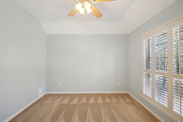 empty room featuring carpet flooring, a ceiling fan, baseboards, and plenty of natural light