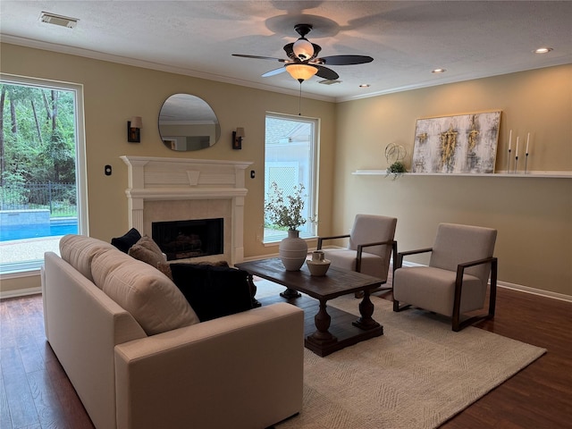 19 Shady Pond Pl, The Woodlands, TX 77382 - living room featuring wood finished floors, a ceiling fan, ornamental molding, a fireplace, and baseboards