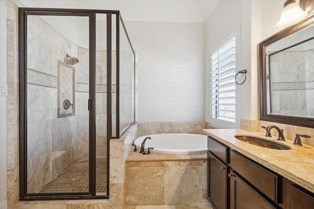 bathroom featuring a garden tub, a shower stall, and vanity