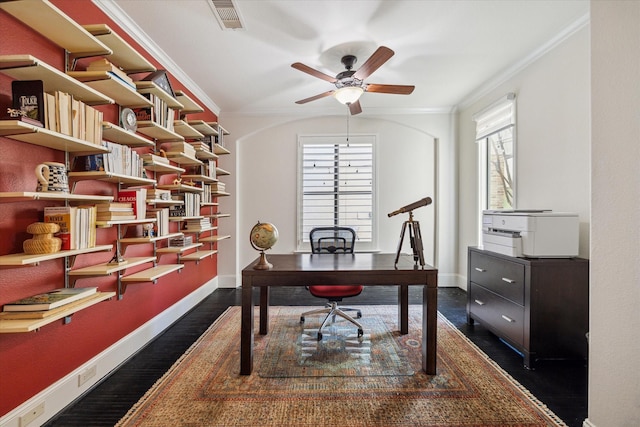 office with dark wood-type flooring, plenty of natural light, visible vents, and crown molding