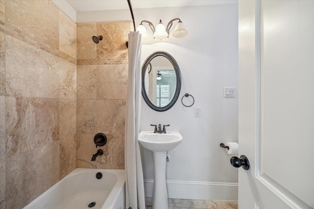 full bathroom featuring baseboards and shower / bathtub combination