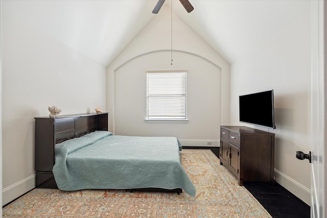 bedroom featuring vaulted ceiling, ceiling fan, wood finished floors, and baseboards