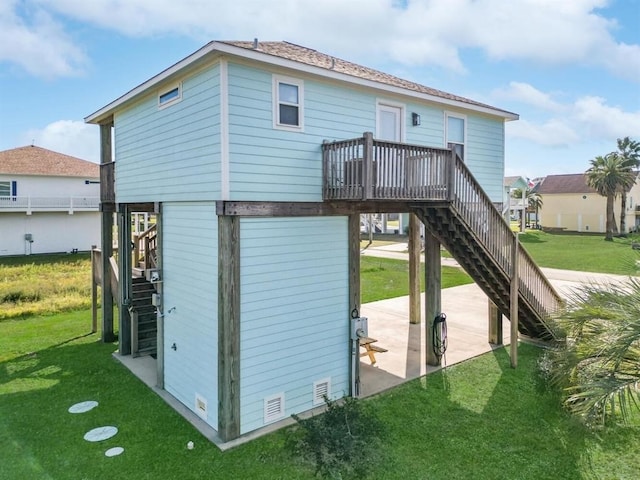 back of property featuring a patio area, stairs, and a yard