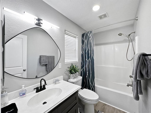 full bath featuring visible vents, wood finished floors, shower / bath combination with curtain, vanity, and a textured ceiling