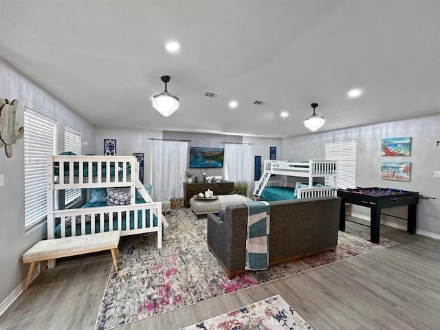 interior space with baseboards, visible vents, wood finished floors, and recessed lighting