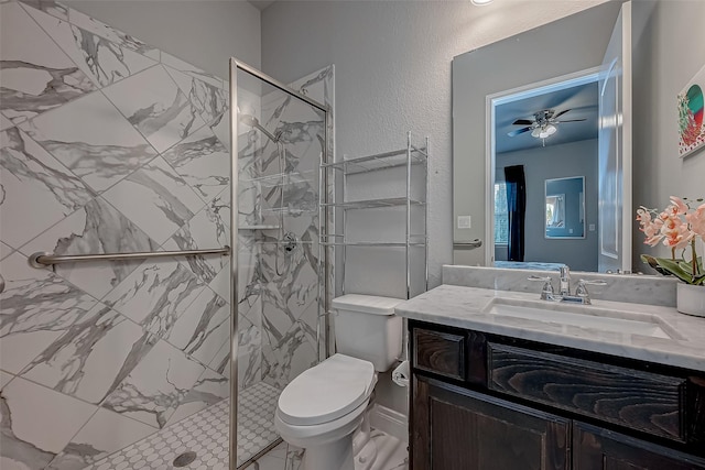 full bath featuring a textured wall, toilet, a ceiling fan, a shower stall, and vanity