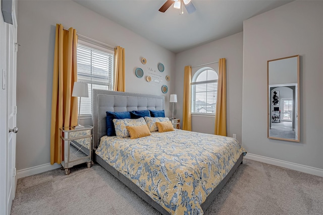 bedroom featuring multiple windows, baseboards, and light colored carpet