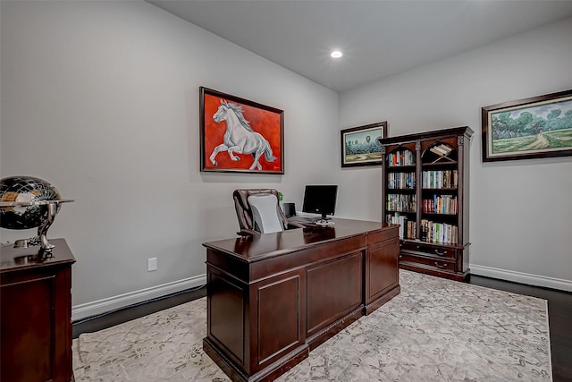 office space with light wood-style floors, recessed lighting, and baseboards