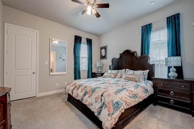 bedroom with light carpet, ceiling fan, and baseboards