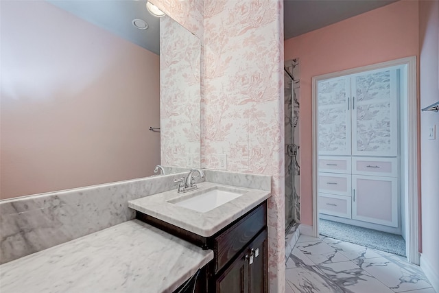 bathroom featuring a shower, marble finish floor, and vanity