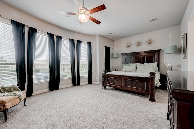 bedroom with baseboards, visible vents, a ceiling fan, and light colored carpet