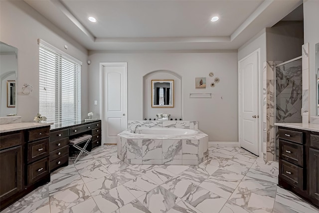 full bathroom featuring a garden tub, recessed lighting, vanity, a shower stall, and a raised ceiling