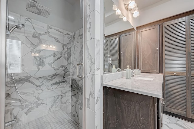 bathroom featuring a closet, vanity, a marble finish shower, and marble finish floor