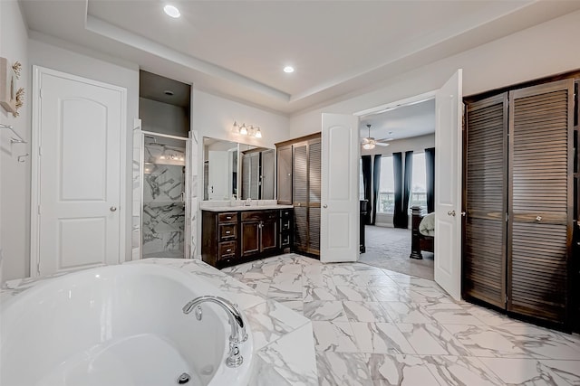 full bath with a raised ceiling, a closet, connected bathroom, and vanity