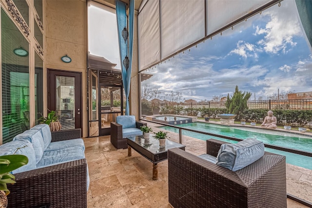 balcony featuring an in ground hot tub, a patio area, and an outdoor living space