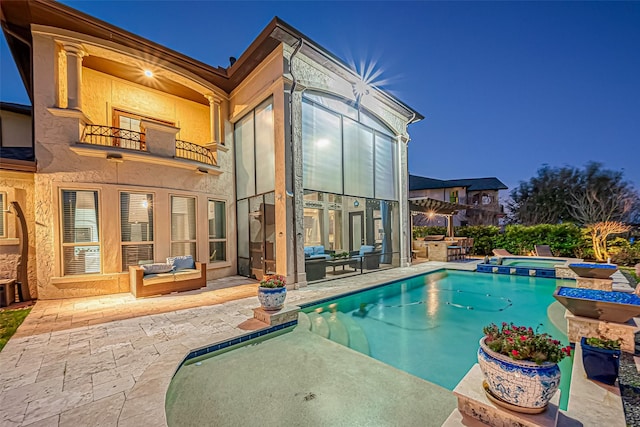 view of swimming pool with a pool with connected hot tub and a patio