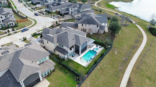 birds eye view of property featuring a water view and a residential view