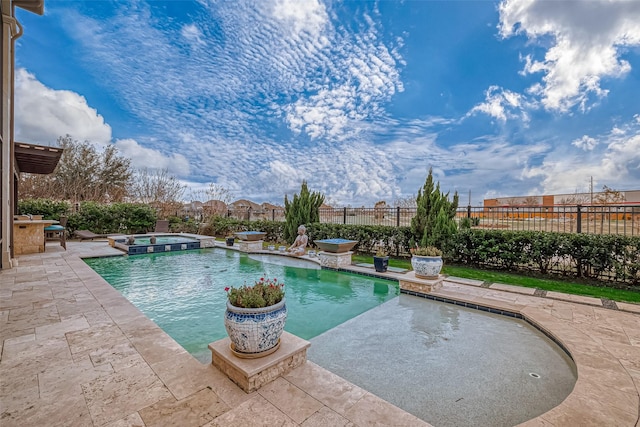 view of swimming pool featuring a pool with connected hot tub, a fenced backyard, and a patio