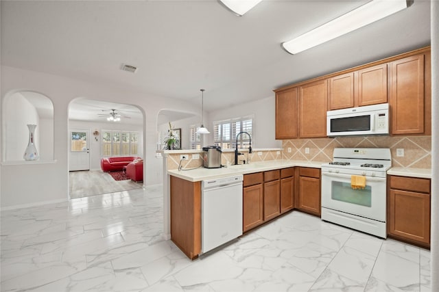 kitchen featuring white appliances, marble finish floor, light countertops, and open floor plan