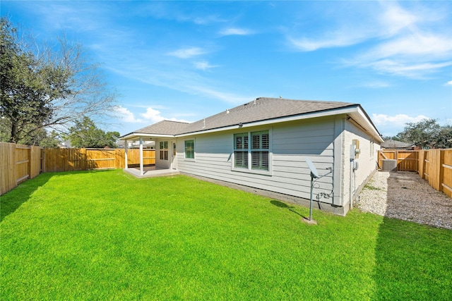 back of property with a yard and a fenced backyard