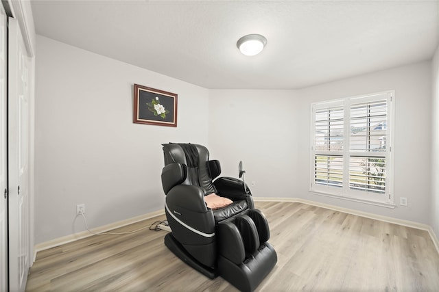 living area featuring light wood-style flooring and baseboards