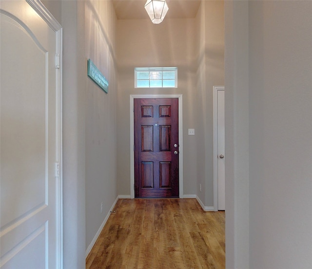 entryway with light wood-type flooring and baseboards