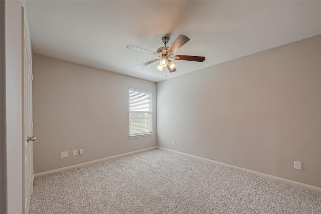 carpeted empty room featuring ceiling fan and baseboards