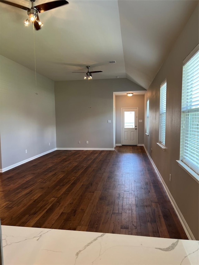 unfurnished living room with lofted ceiling, ceiling fan, baseboards, and dark wood-type flooring